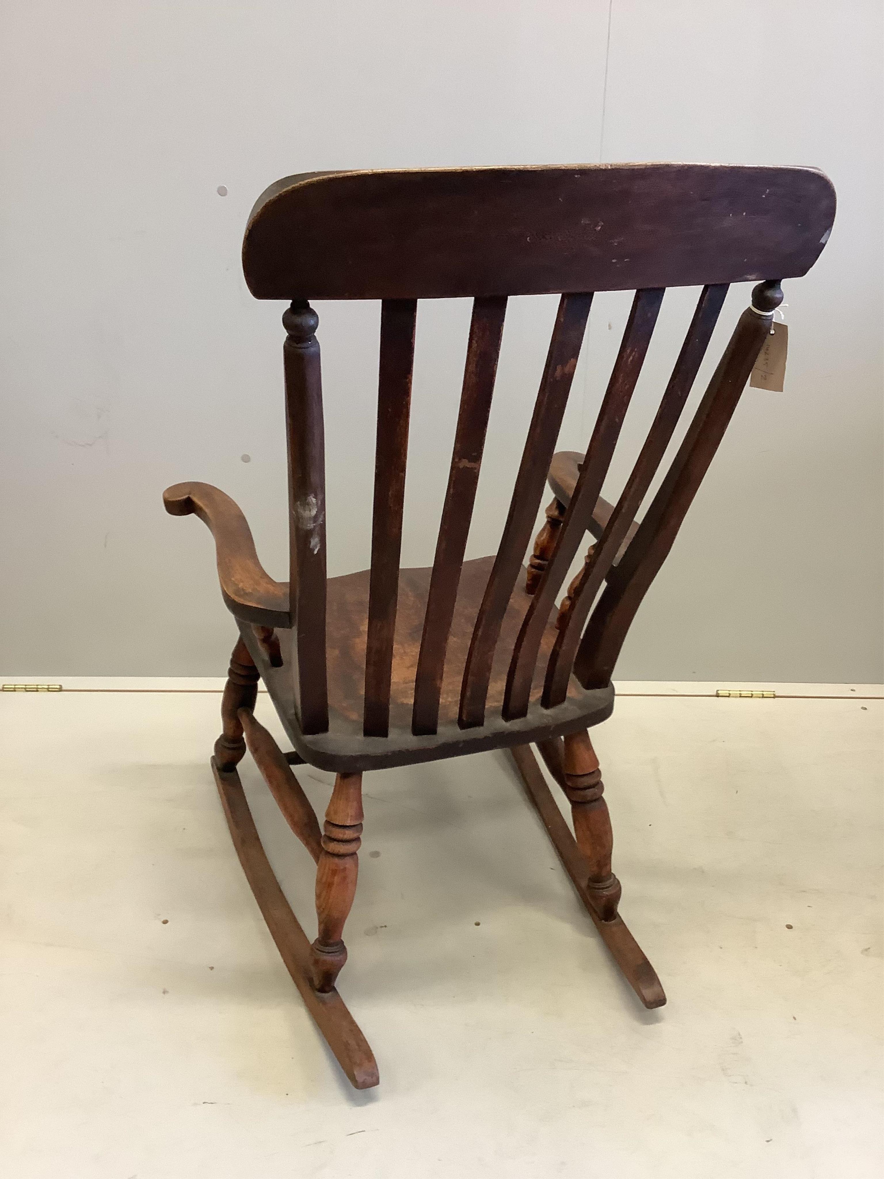 A Victorian elm and beech Windsor lathe back rocking chair, width 63cm, depth 45cm, height 102cm. Condition - fair